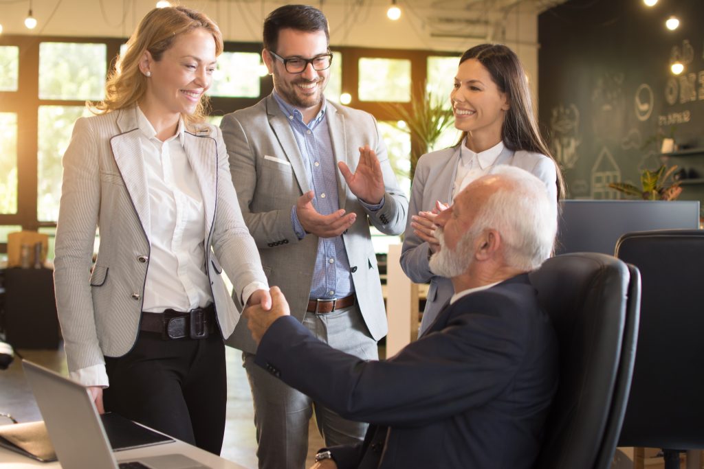 Business people shaking hands, finishing up a meeting in modern